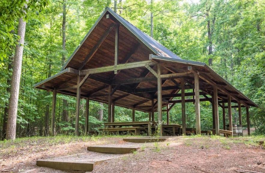 view of large wooden shelter in the woods