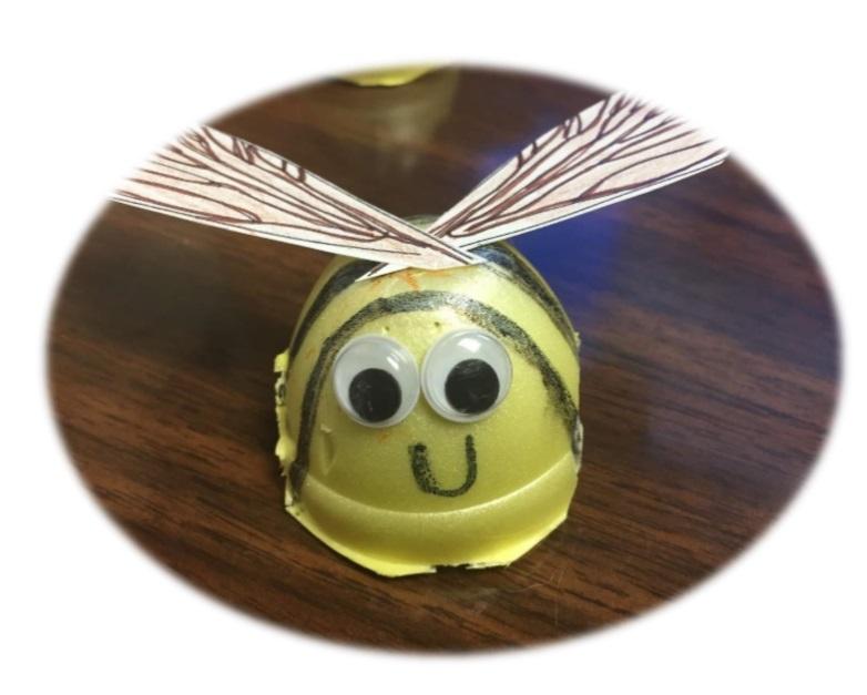 yellow egg carton bee craft with paper wings and googly eyes