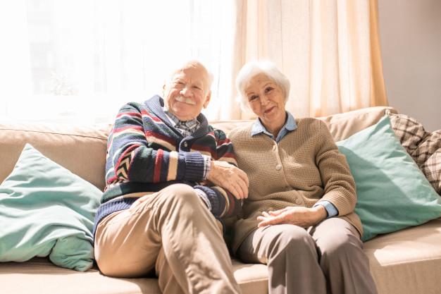 Elderly couple relaxing on a sofa.