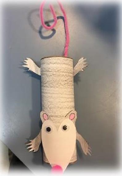 Paper tube craft that looks like opossum with googly eyes and pink puff ball nose