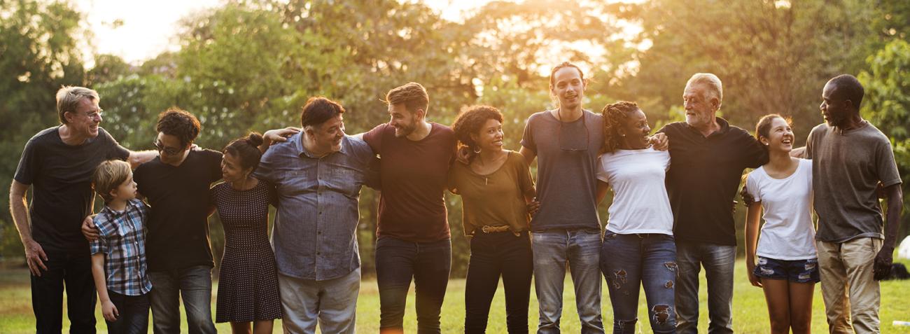 group of people support in unity with arms around each other