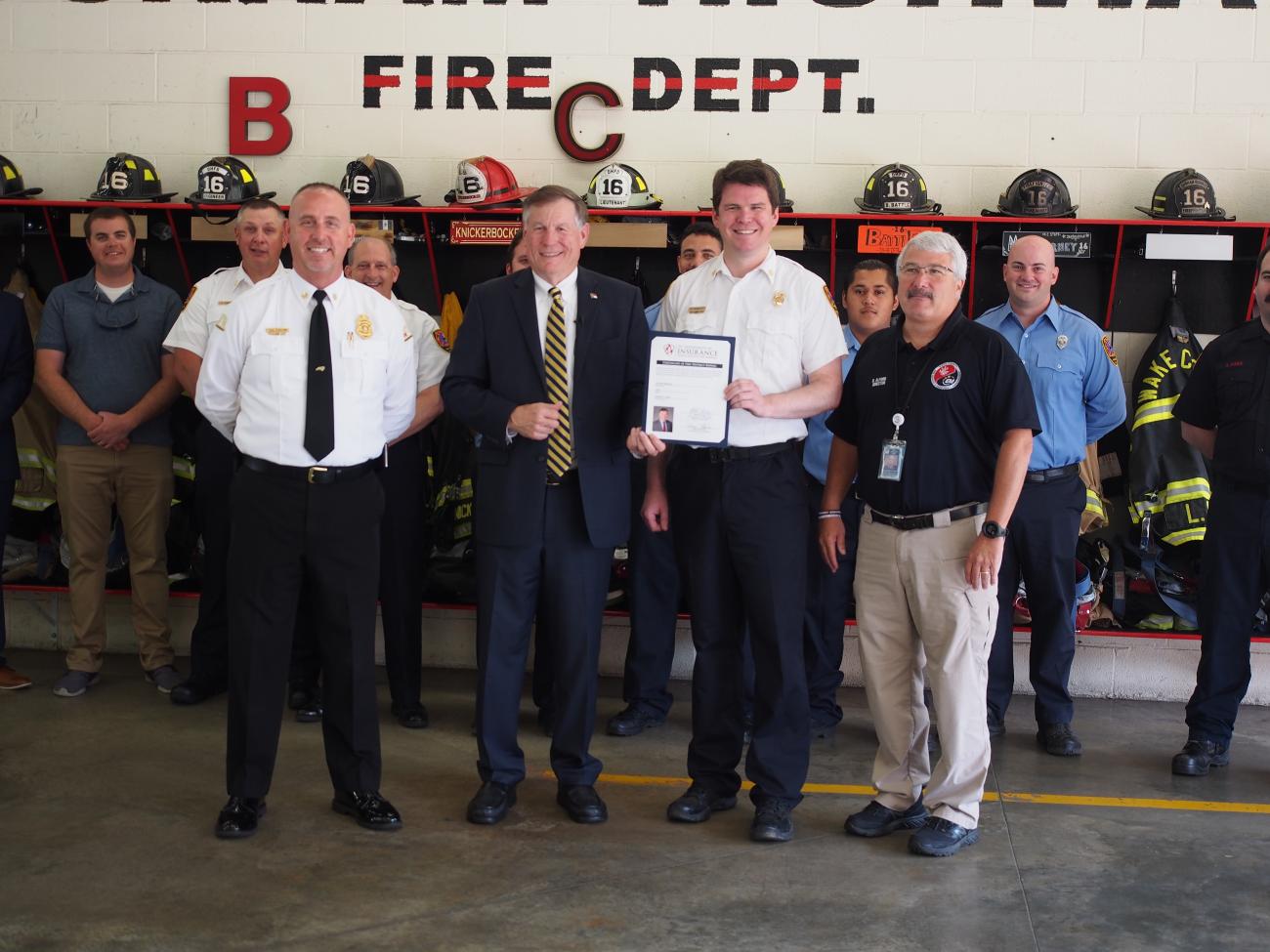 NC Insurance Commissioner Mike Causey and Wake Fire Services director Darrell Alford stand with Durham Highway FD staff members