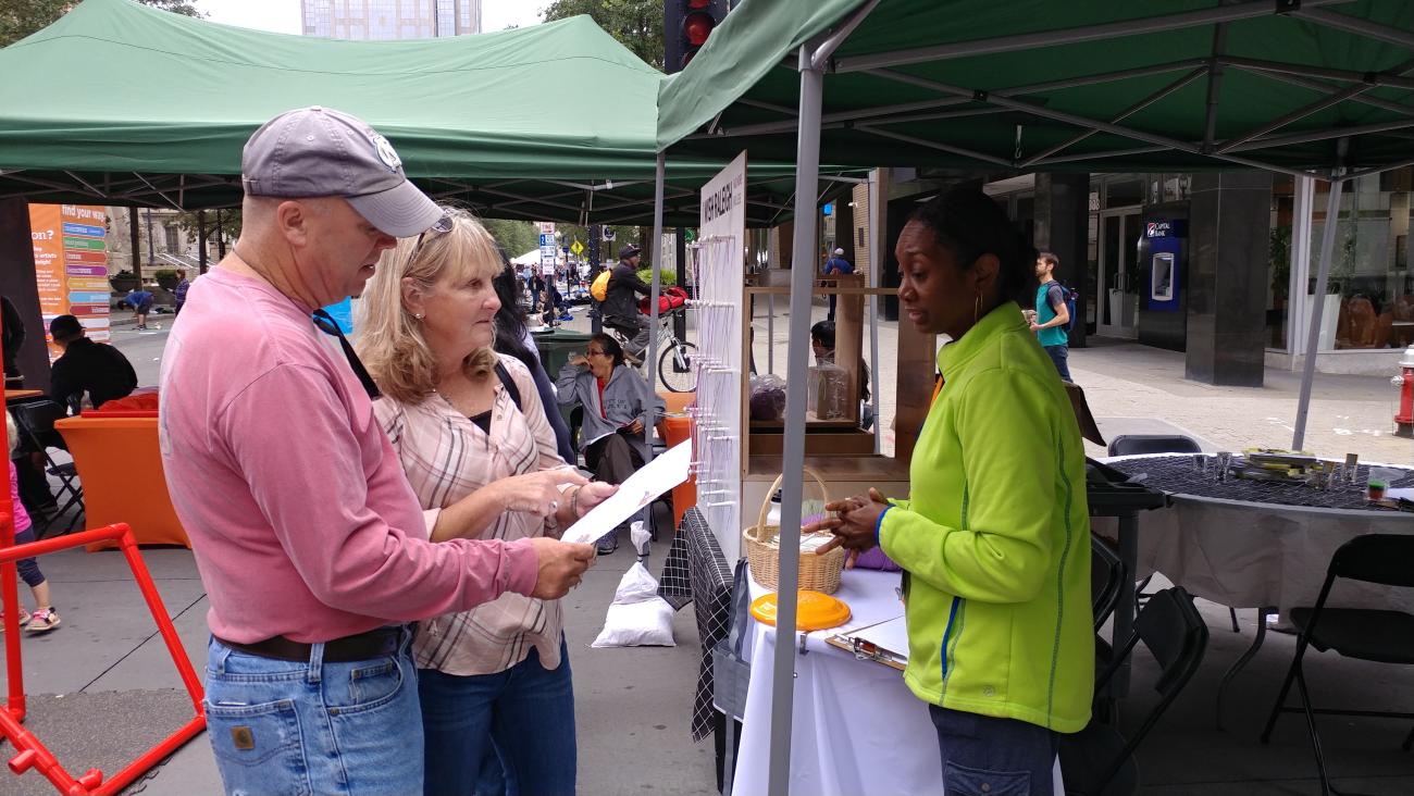 Residents take a survey at a festival.