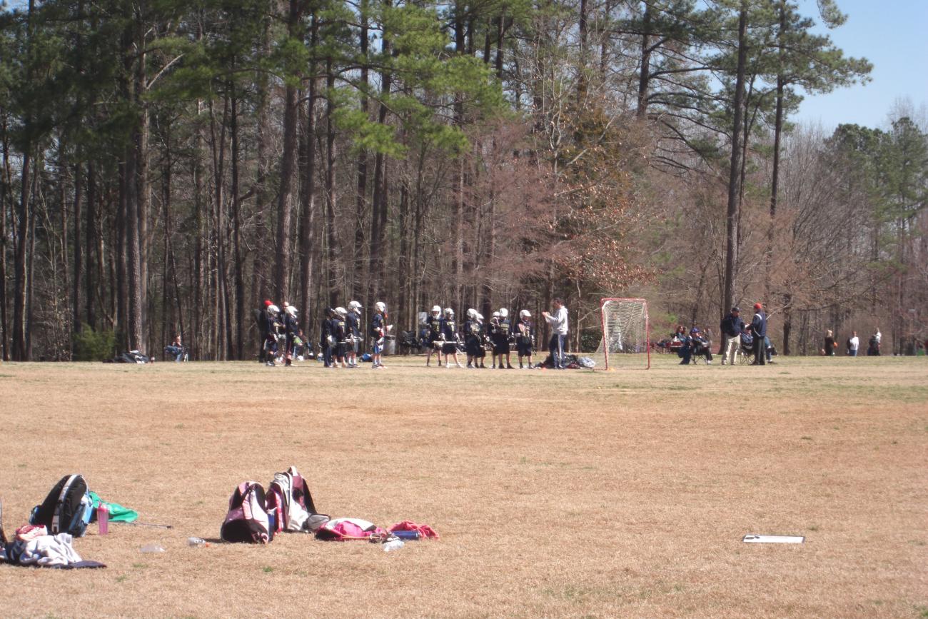 Youth lacrosse players on main open play field