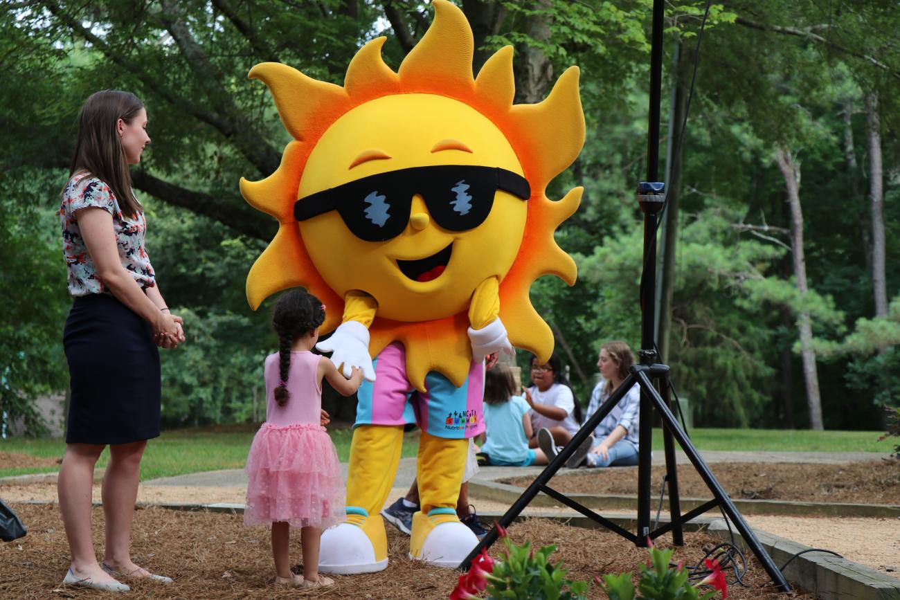 child at summer food kick off with mascot