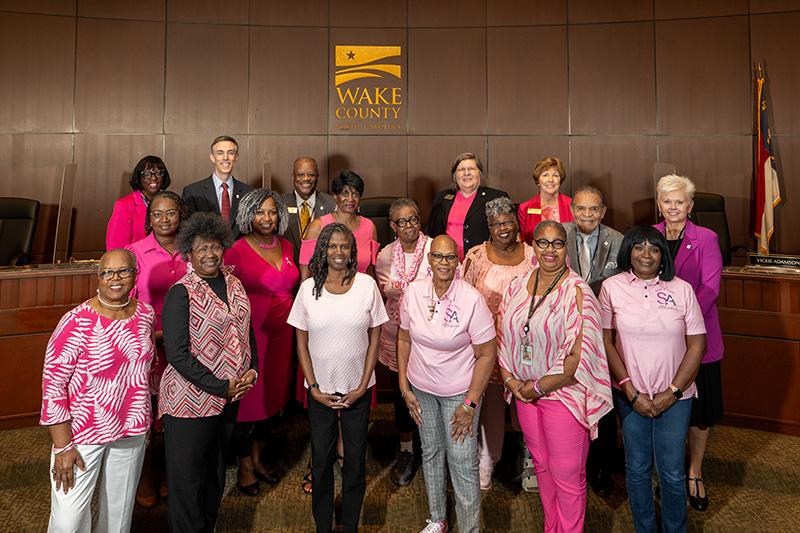 Women dressed in pink join Wake County Commissioners in board chamber