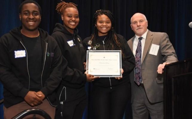 Youth leaders hold award earned for poster presentation