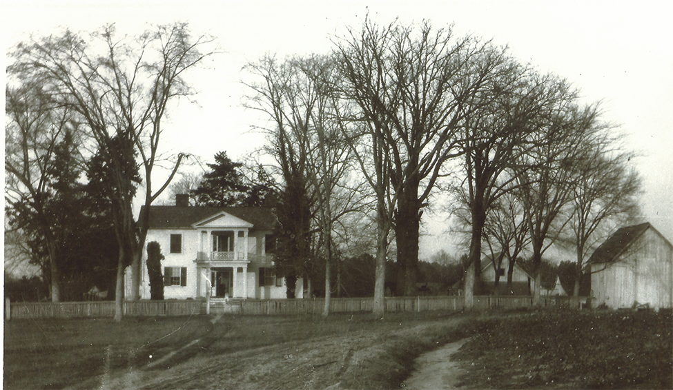 Historic black and white image of the Oak View farmhouse from the early 1900s