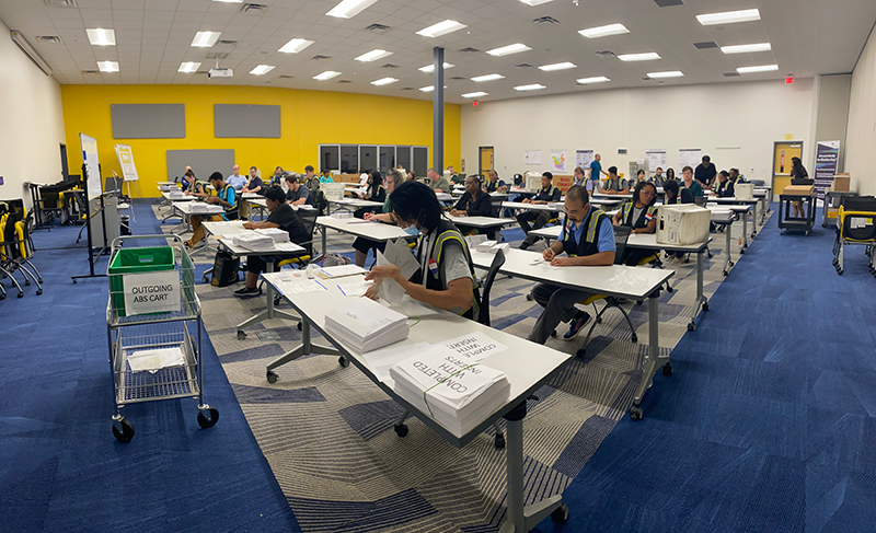 Workers process absentee ballots