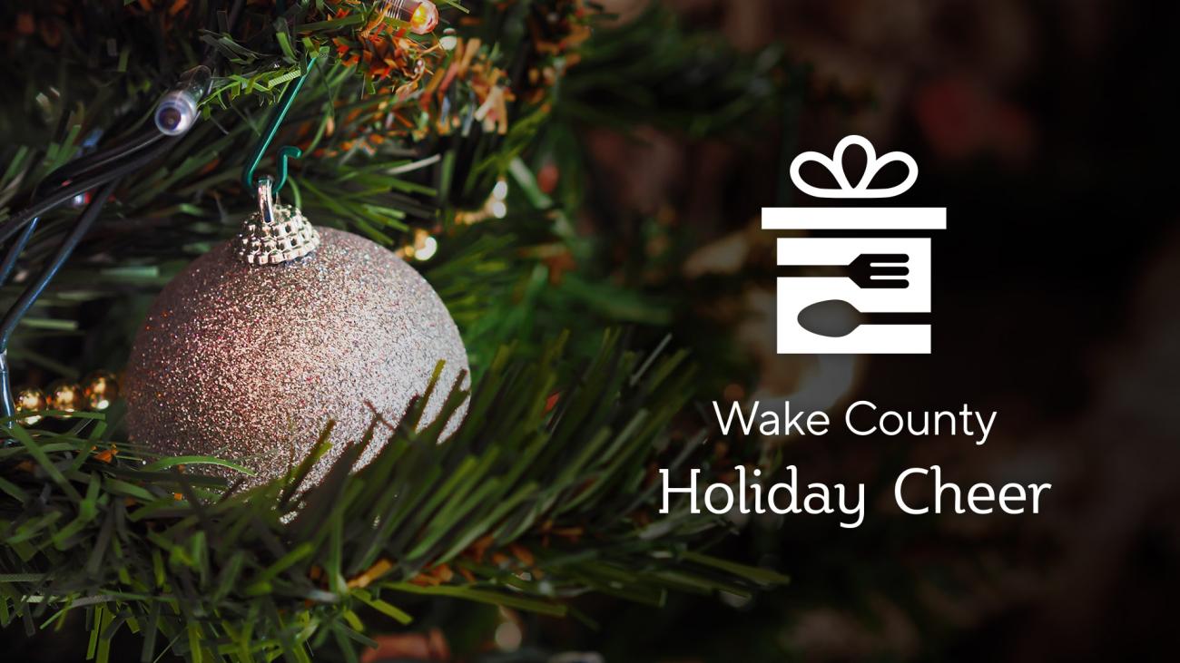СѼƵ County Holiday Cheer program logo, with ornament in Christmas tree