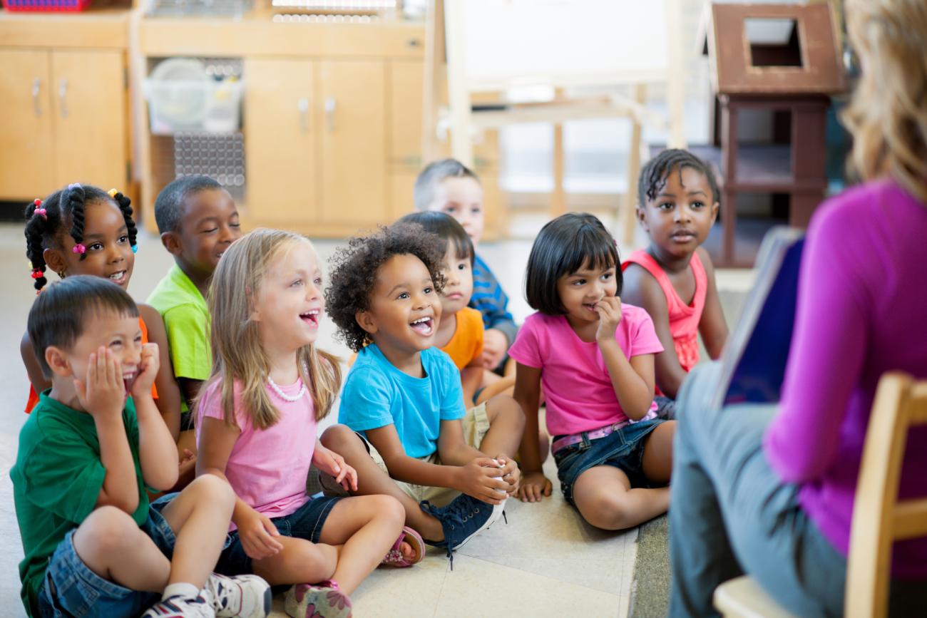 Children with teacher in childcare center classroom 
