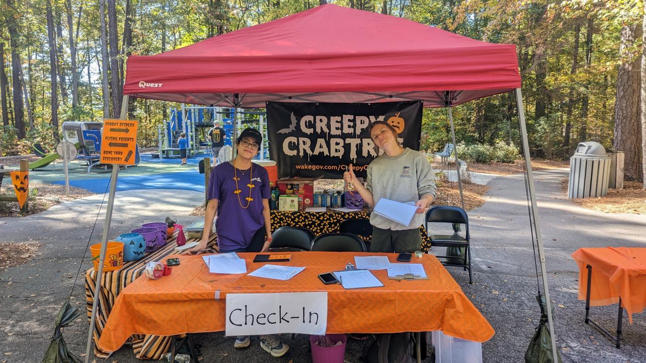 Volunteer and staff member at the event check in table