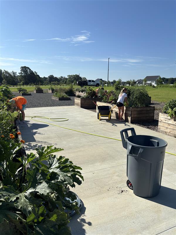 Volunteers caring for plant beds in Beech Bluff County Park's demonstration garden.