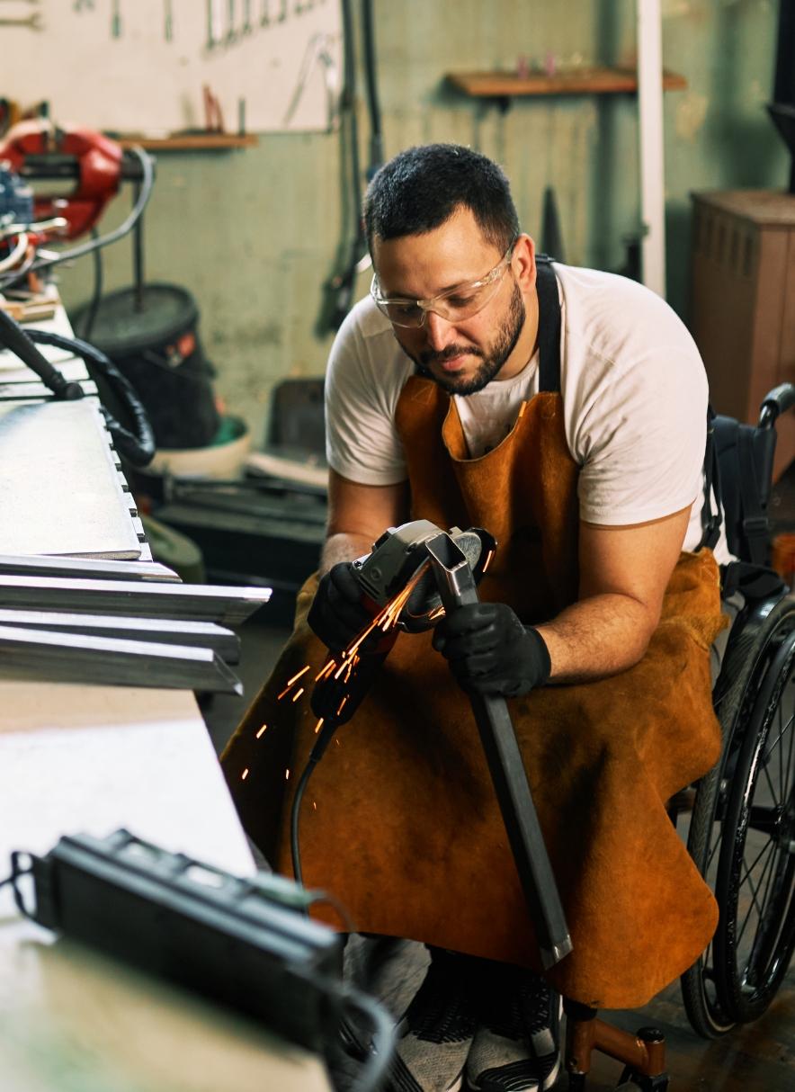 Machinist working with tools in workspace