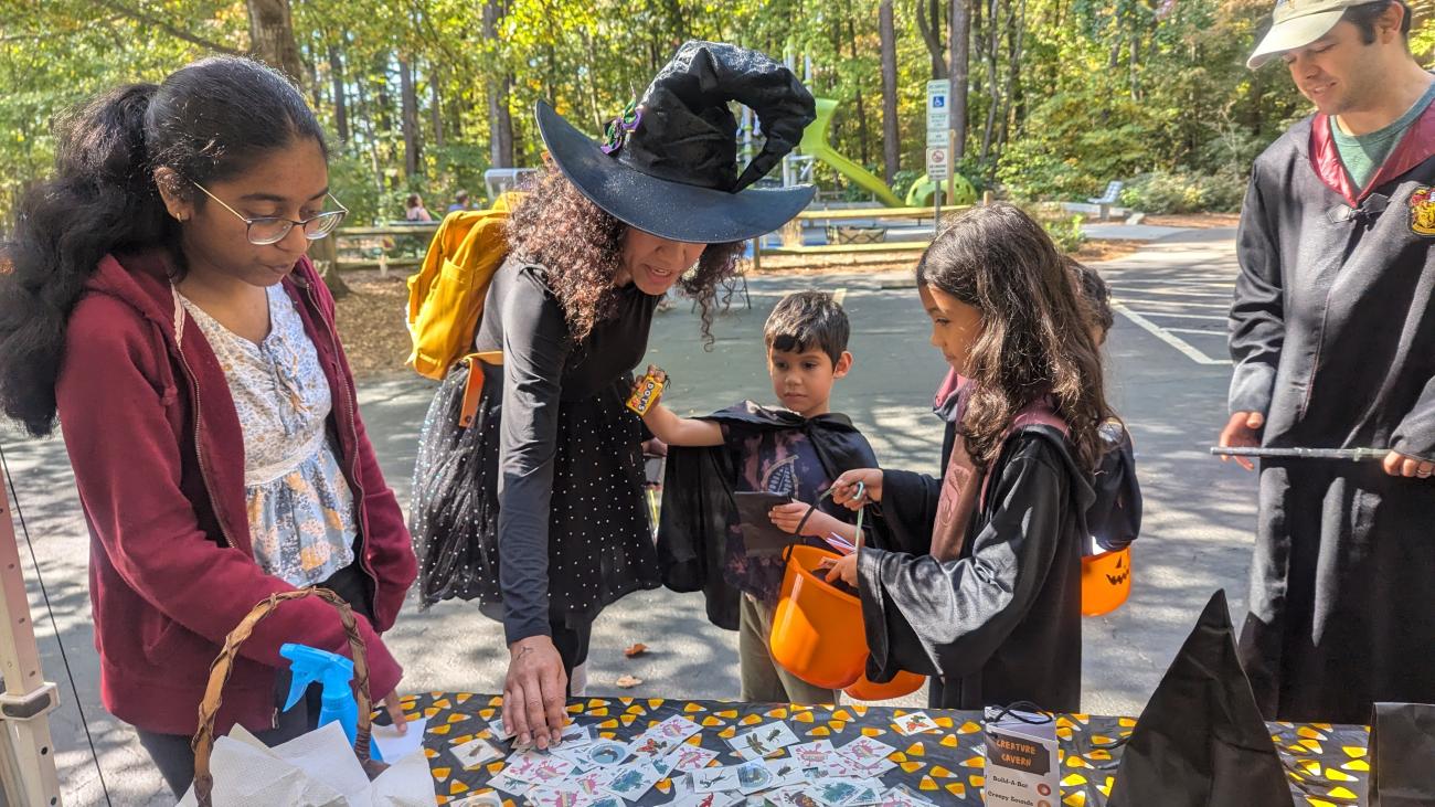 family in halloween costumes at park event
