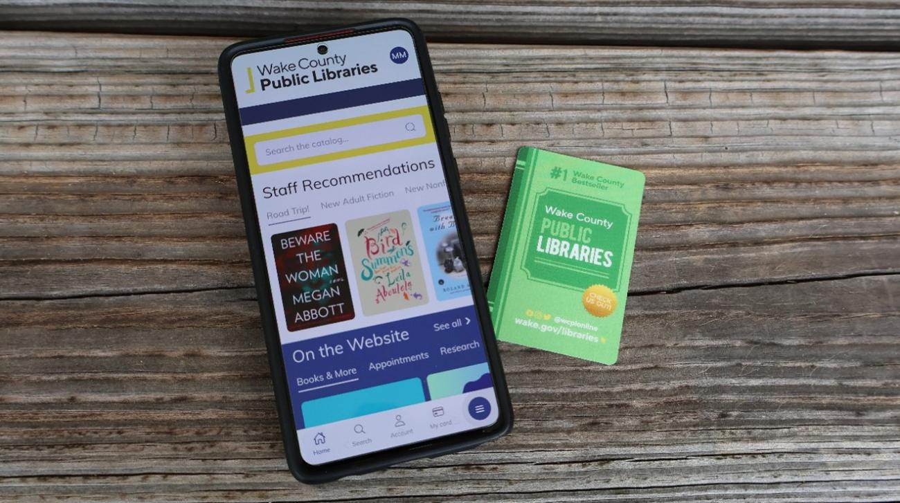 phone with WCPL Mobile app and library card