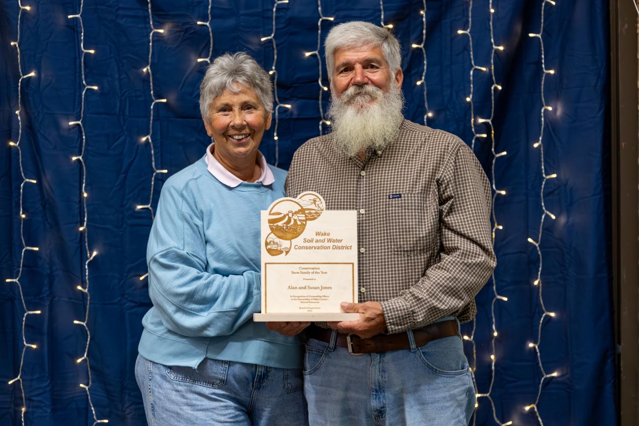 man and woman hold award