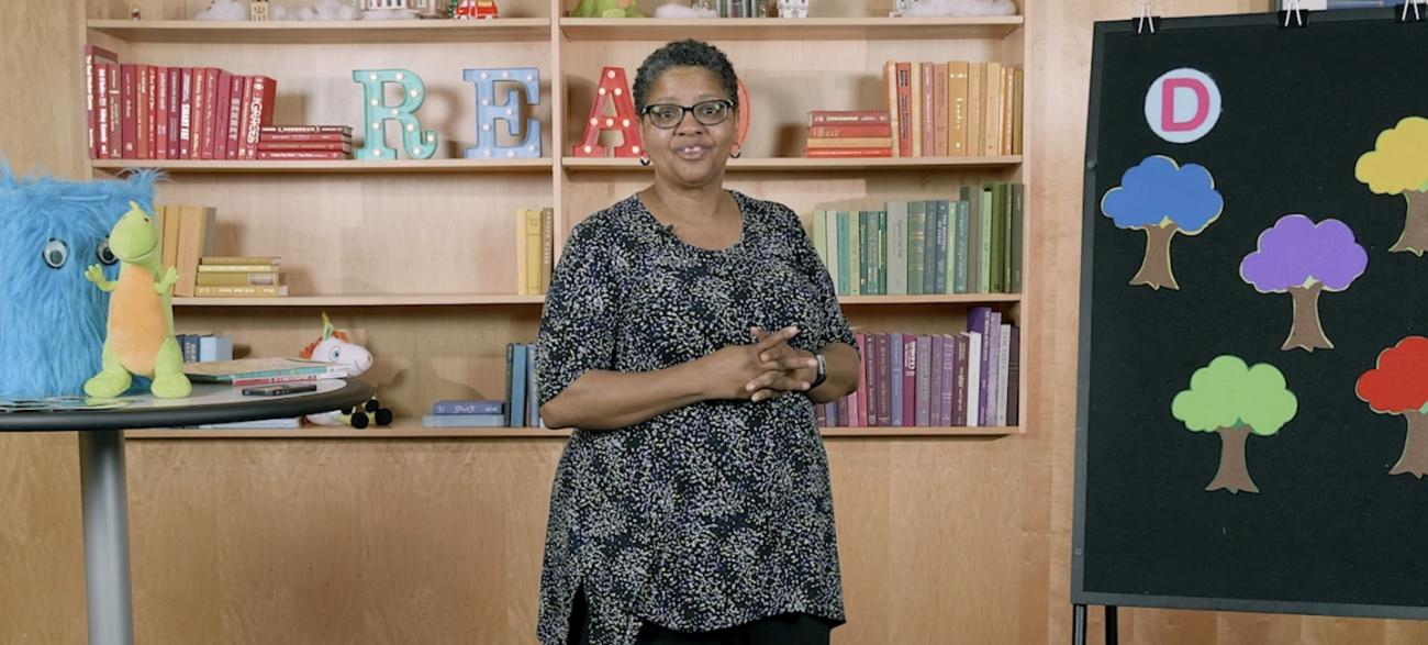 Storytime Image of Librarian in front of bookshelves