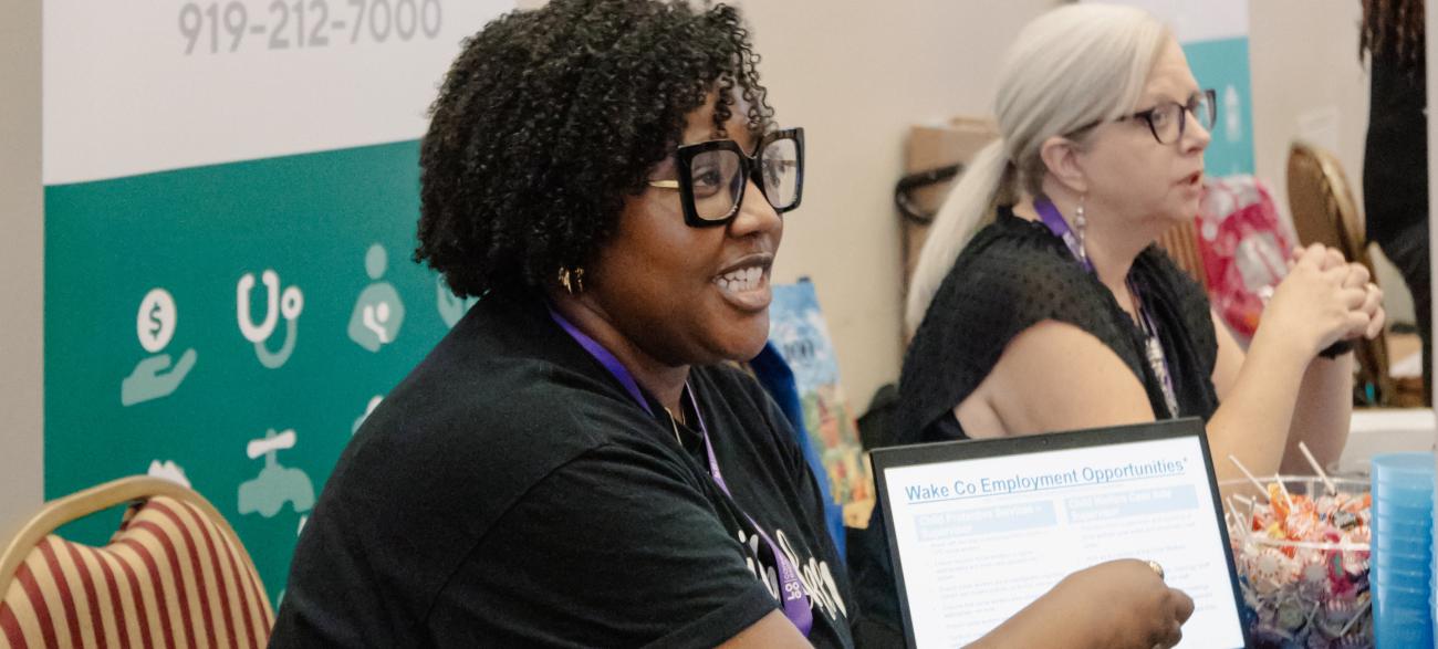 Public Health Employee speaking with someone at an event