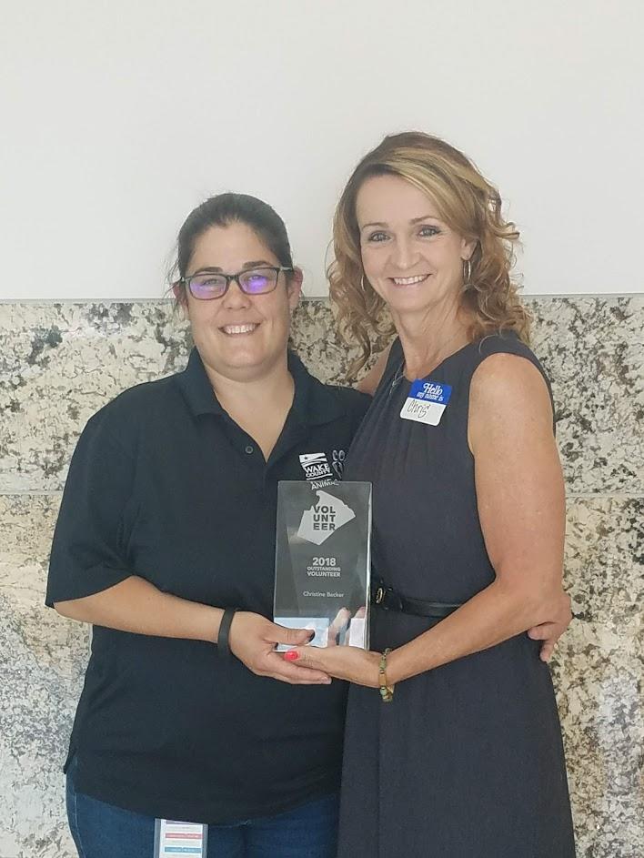 Christine Becker receives her volunteer award from Animal Services Director Dr. Jenn Federico.