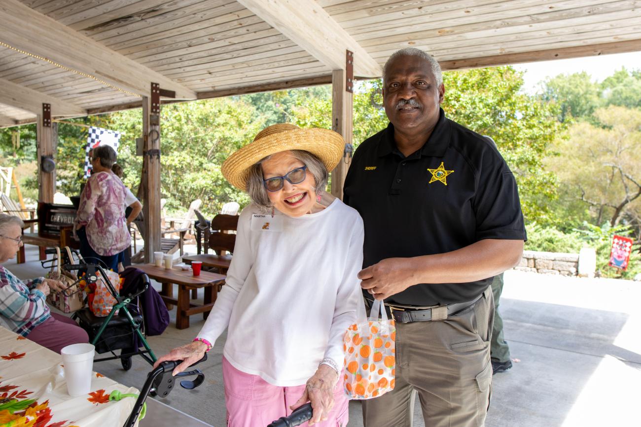 Sheriff Rowe and a member of the Well Check Program smiling 