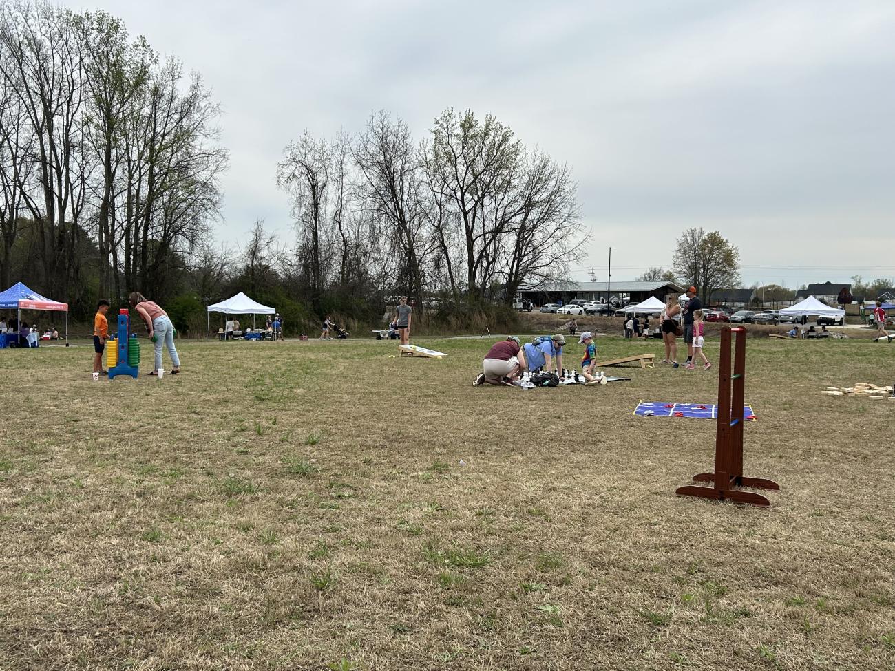 Families playing various giant games on the Great Lawn at Beech Bluff County Park during the Beech Bluff Bash.