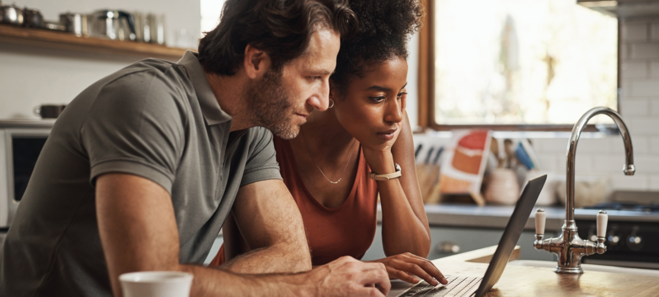kinship caregivers looking at a laptop in their home