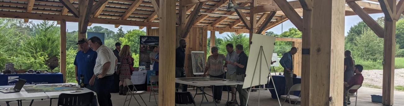 People at a park shelter talking and interacting