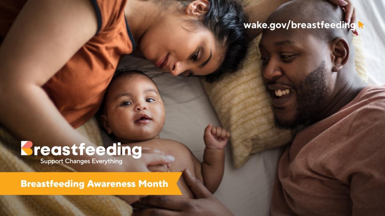 Parent and infant lie together on a bed while another parent smiles at them. Graphic promoting Breastfeeding Awareness Month with the message "Breastfeeding: Support Changes Everything" and the website wake.gov/breastfeeding.