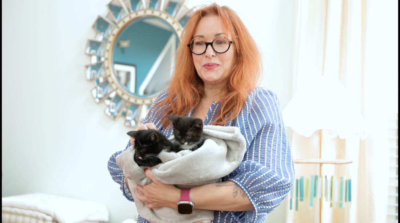 Elle caring for foster kittens in her home