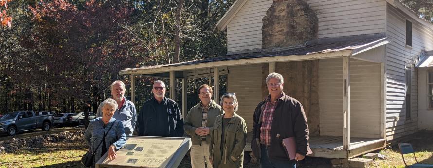 Members of the Historic Preservation Commission pose in front of the historic H.B. Wells Farm