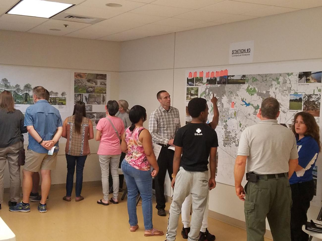 staff and public discuss projects in public meeting