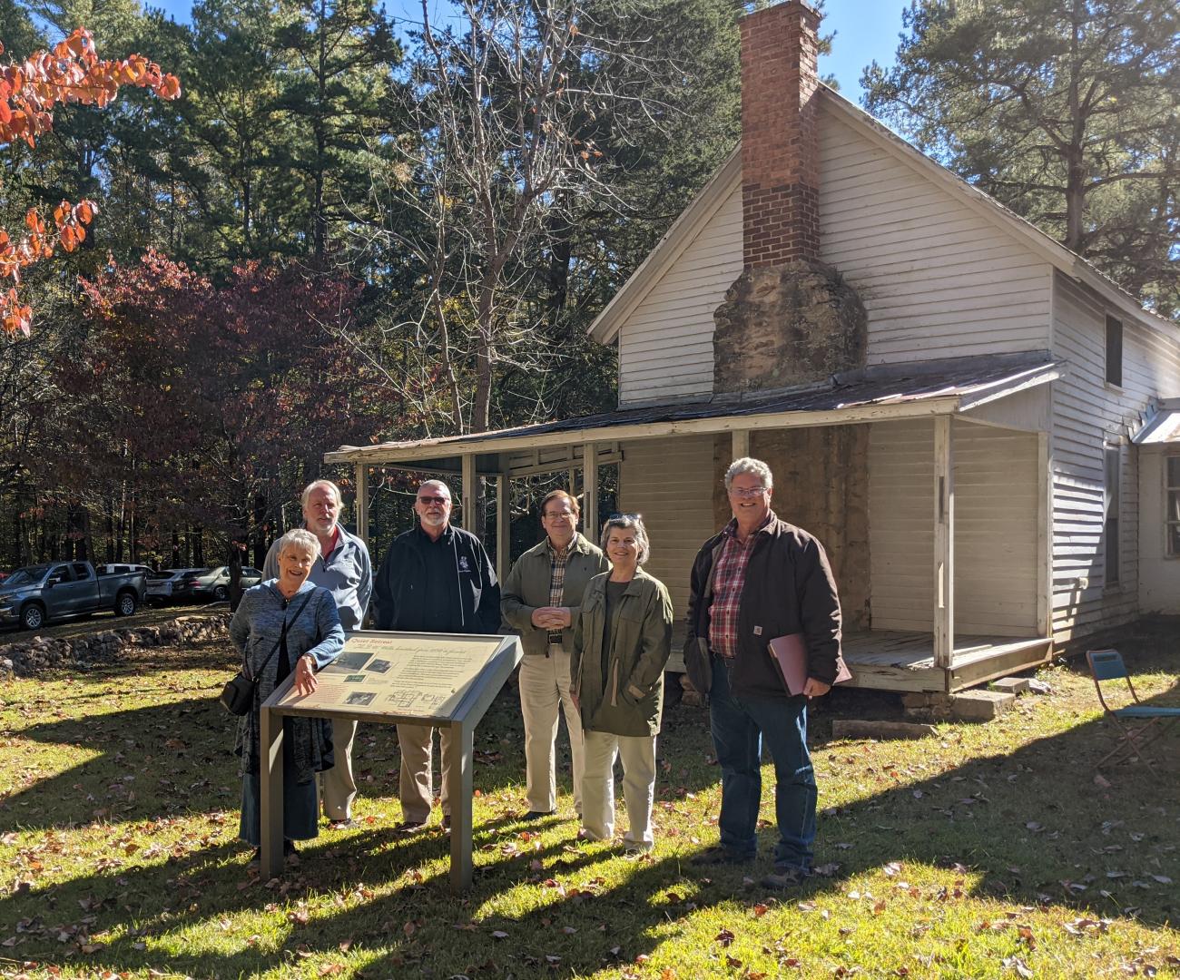 Members of the Historic Preservation Commission pose in front of the historic H.B. Wells Farm