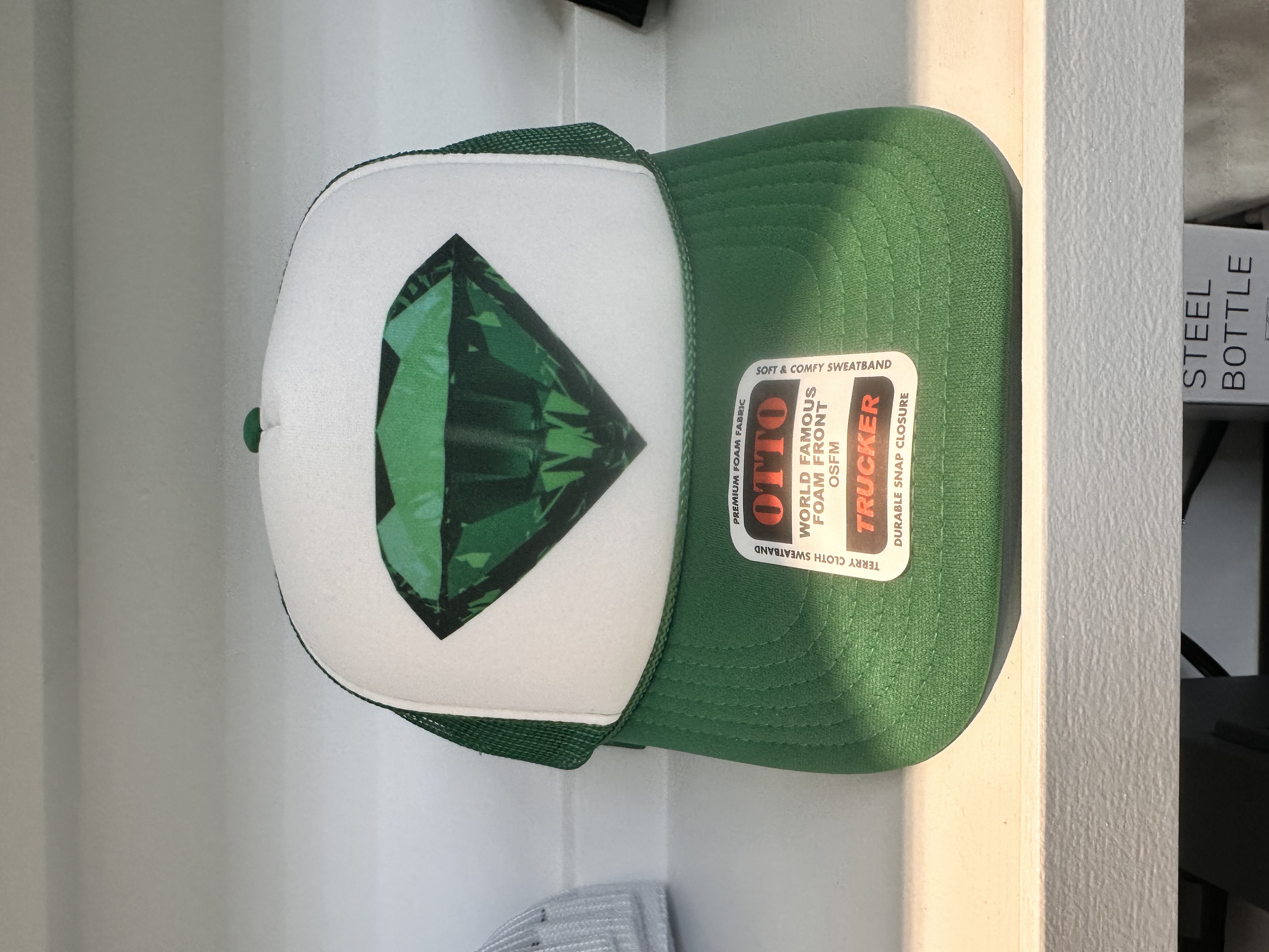 Photograph of product: Emerald Dispensary | Gemstone Trucker Hat | Green