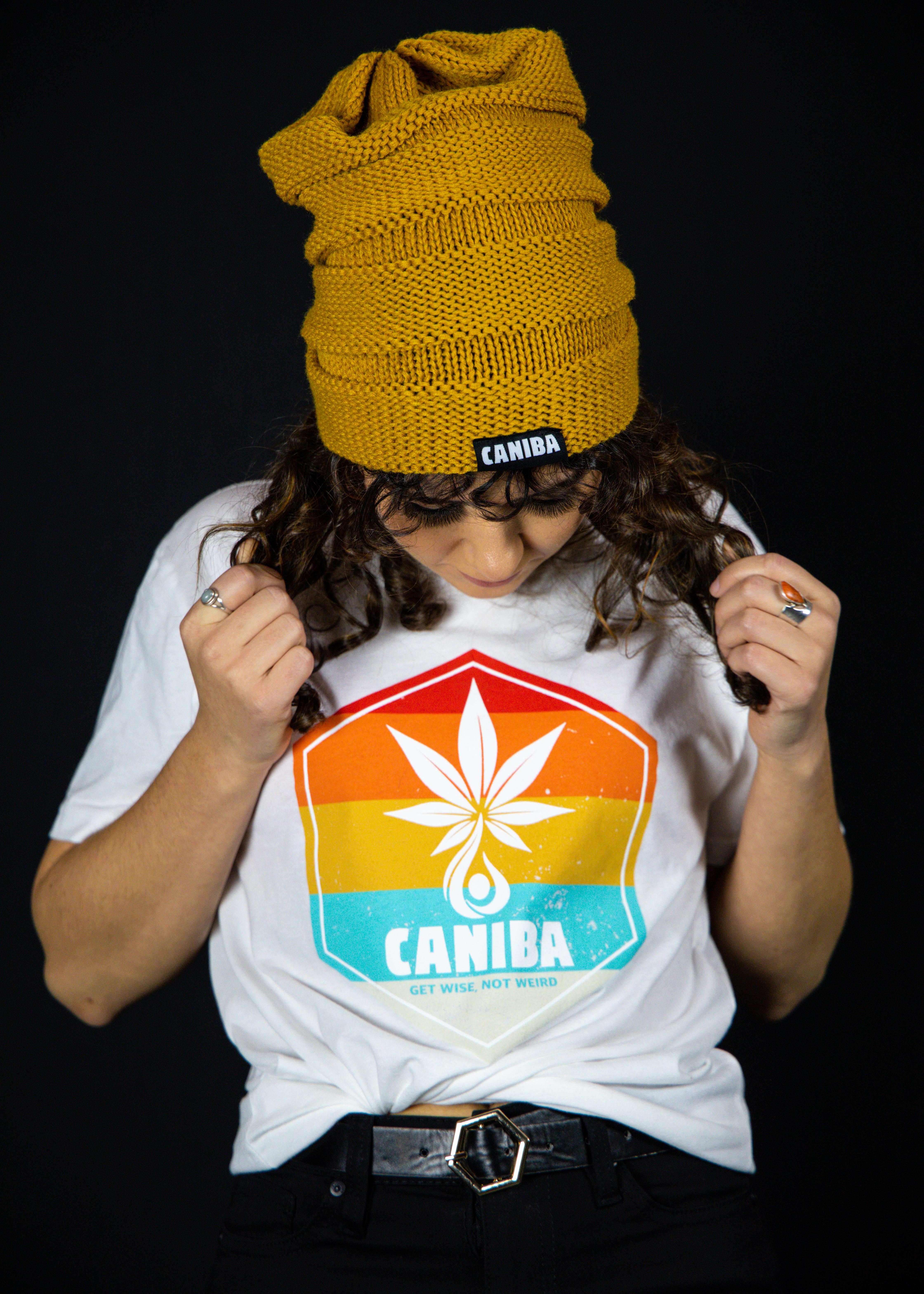 Photograph of product: T-Shirt. M. White. Hexagon Badge. Caniba