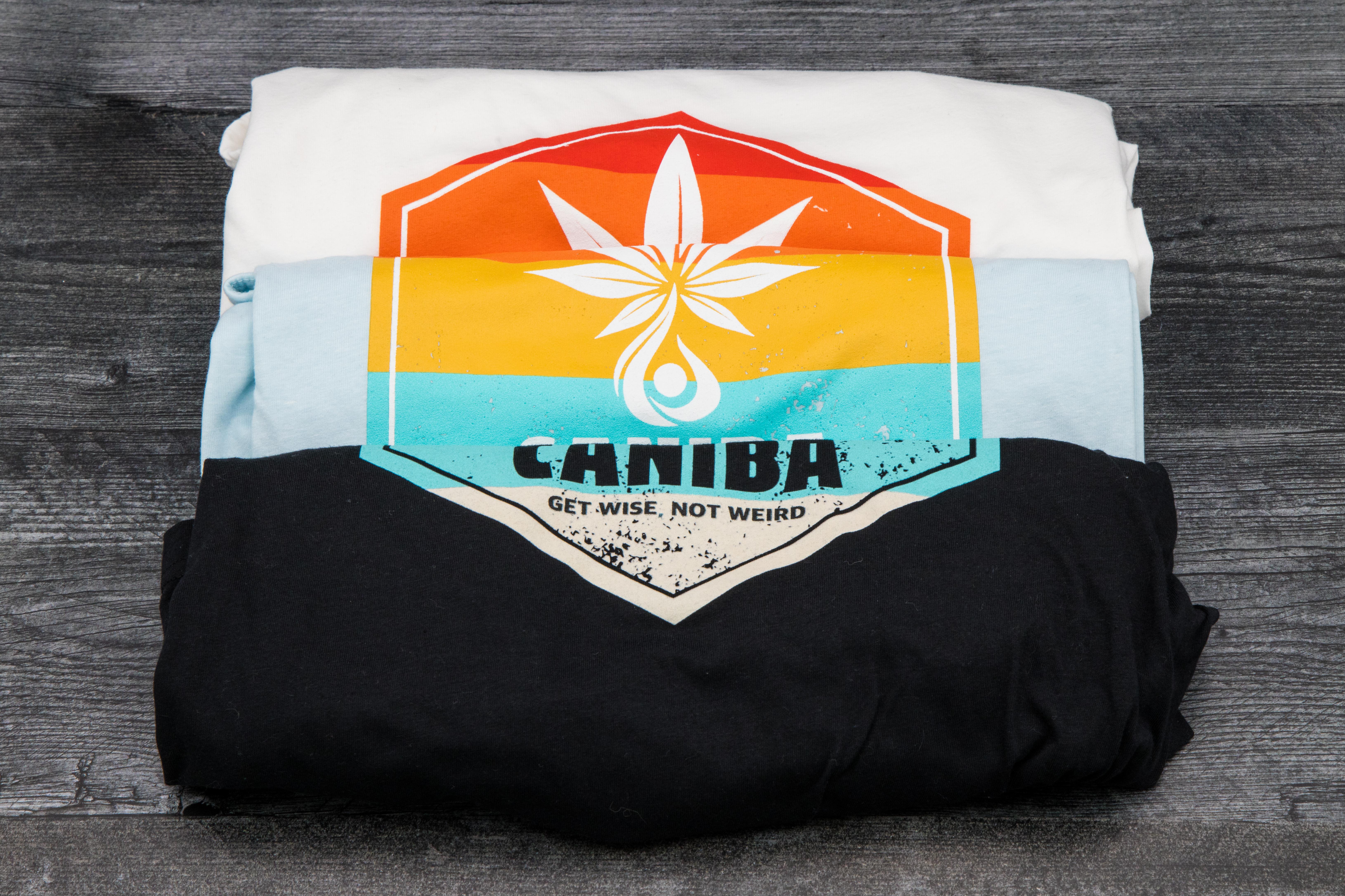 Photograph of product: T-Shirt. S. Black. Hexagon Badge. Caniba