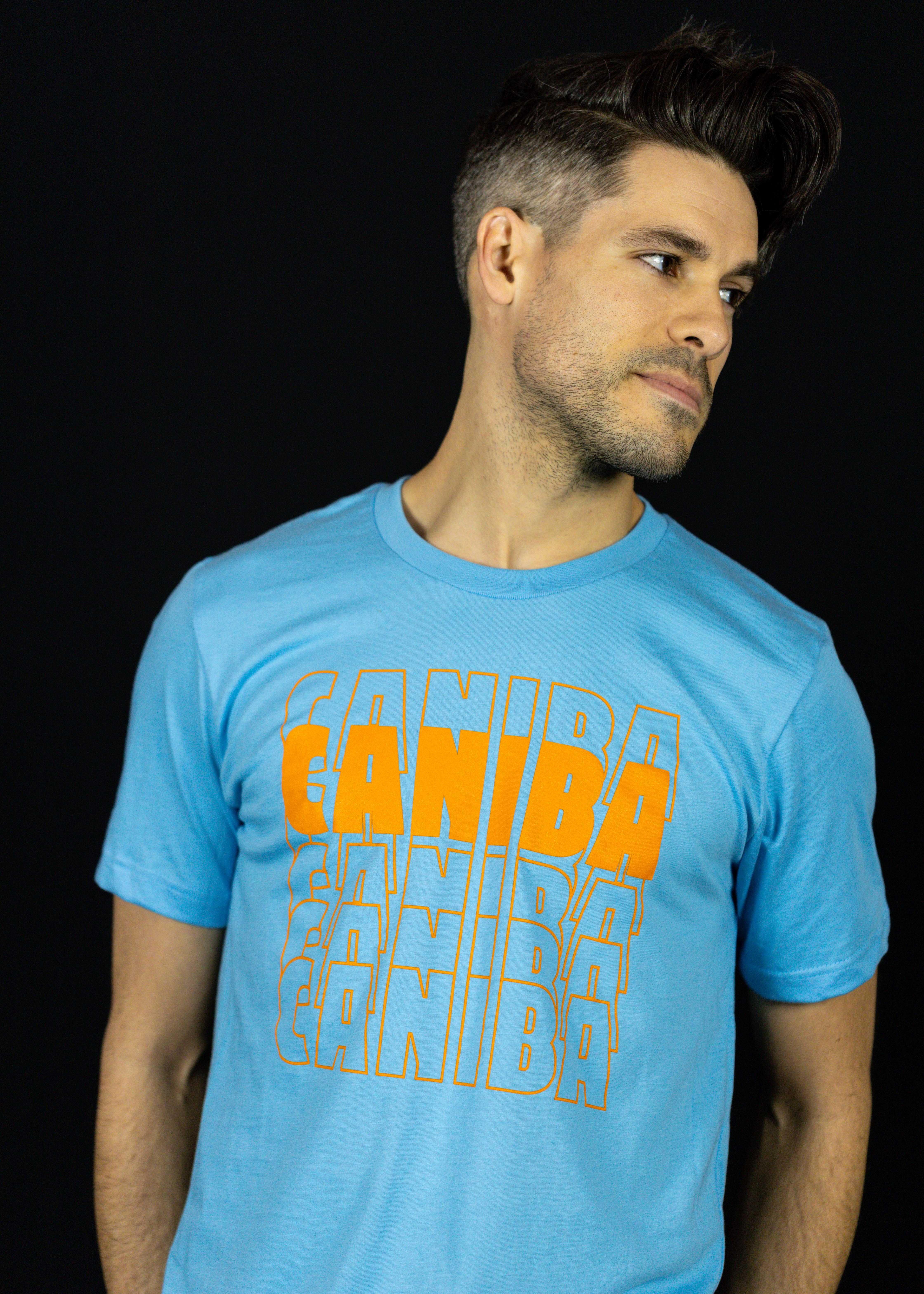 Photograph of product: T-Shirt. XS. Blue. Caniba Text. Caniba