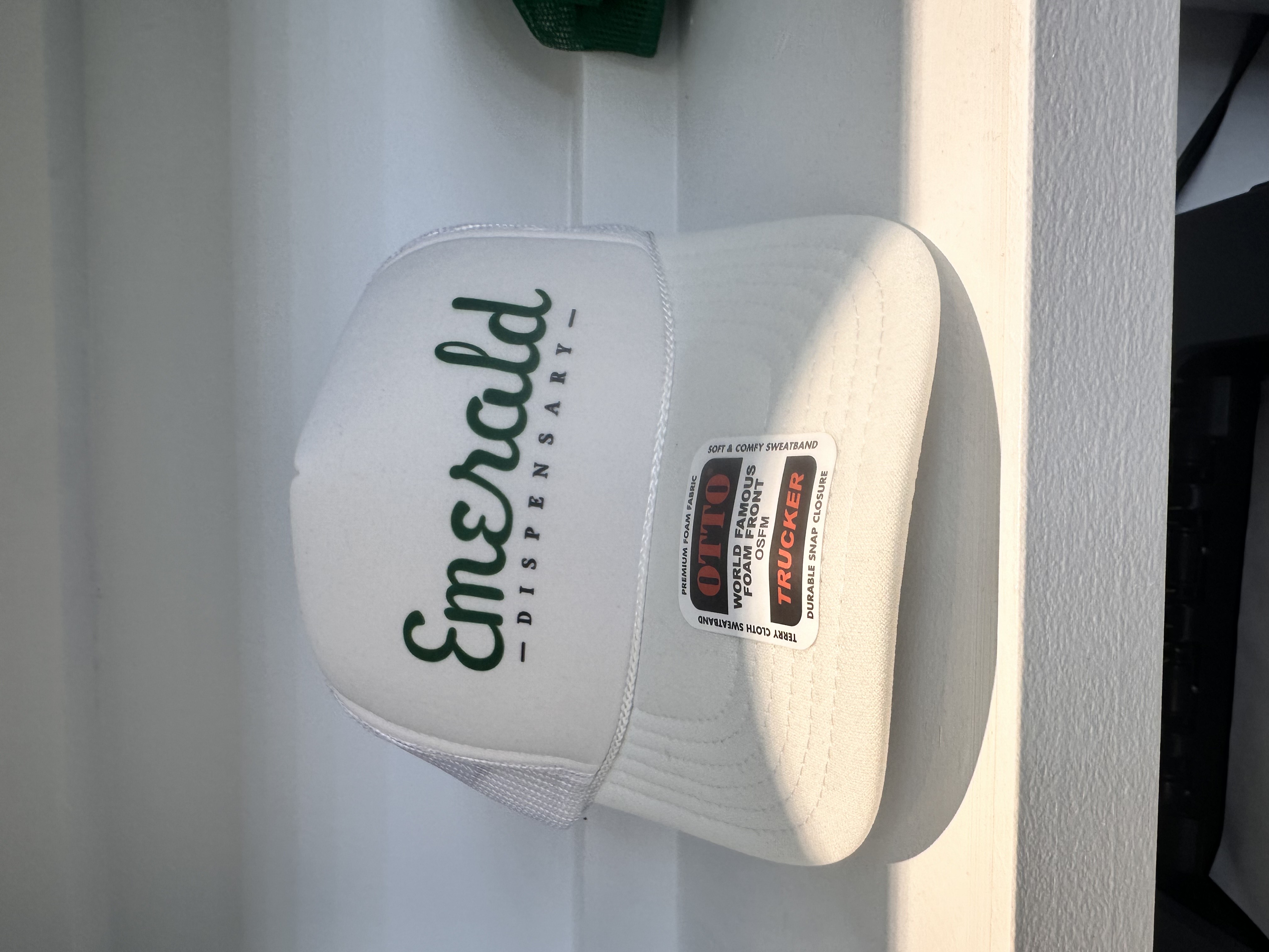 Photograph of product: Emerald Dispensary | Trucker Hat | White