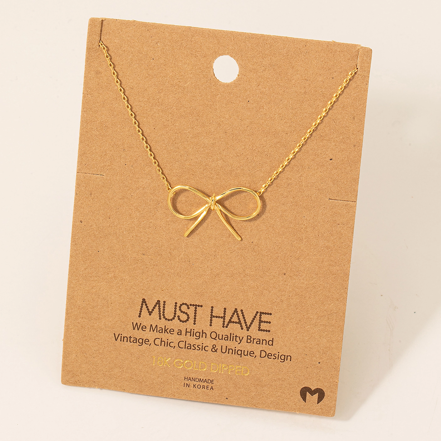Photograph of product: Gold Dipped Bow Tie Pendant Necklace - Gold