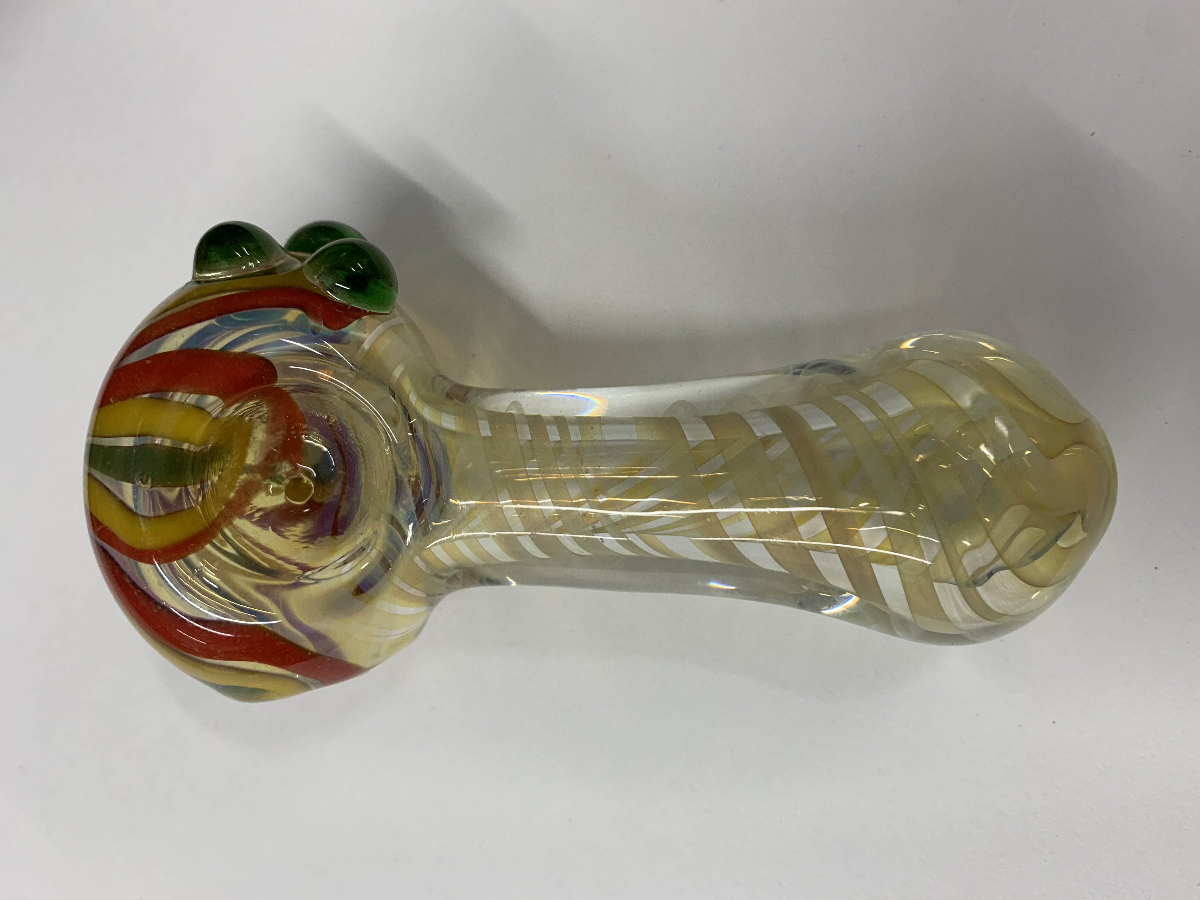 Photograph of product: Glass - 4" Thick Color changing Swirl Rasta Flower Pipe - P3088