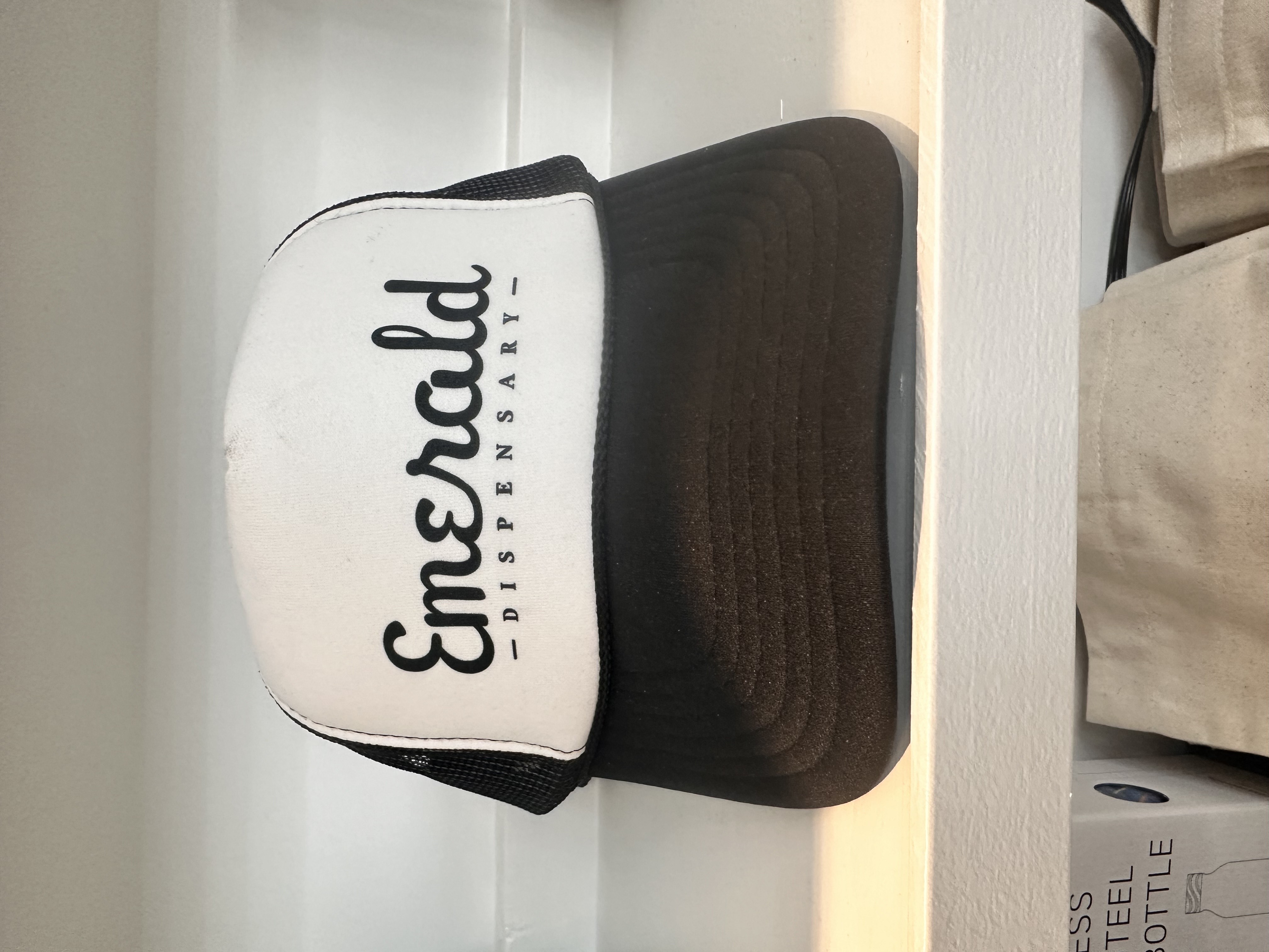 Photograph of product: Emerald Dispensary | Trucker Hat | Black & White