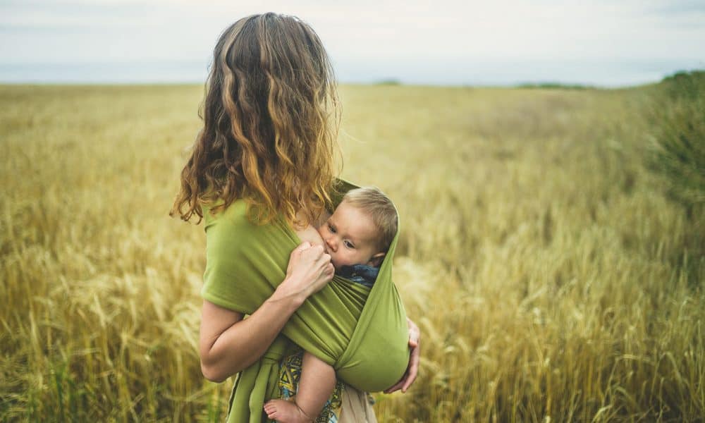 woman in the fields breastfeeding