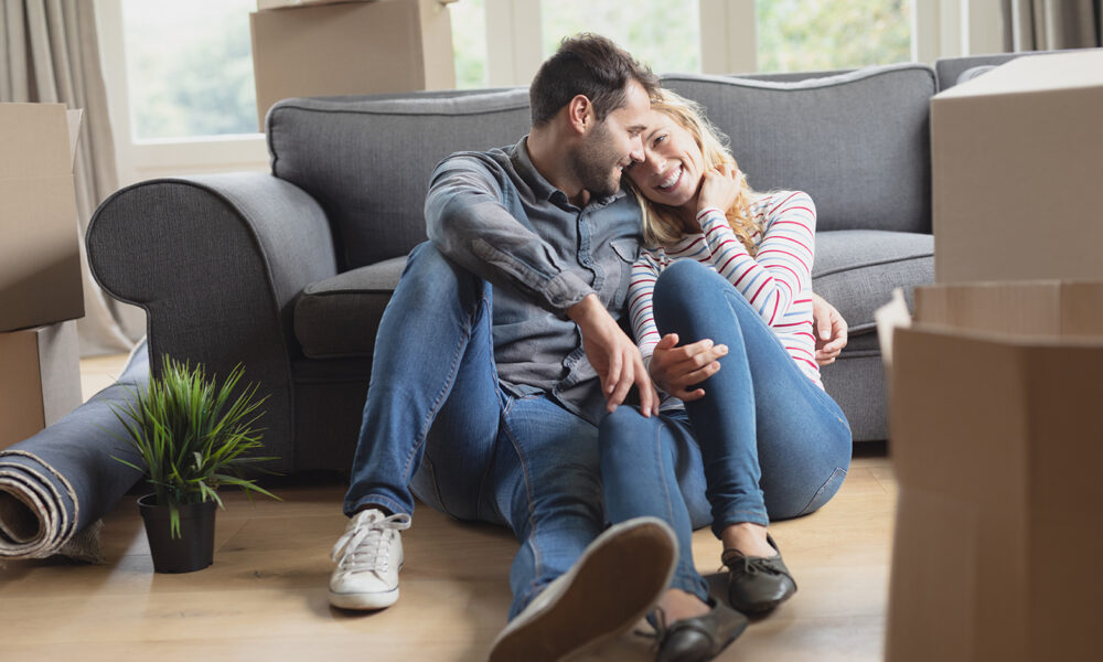 couple-cuddling-on-living-room-floor