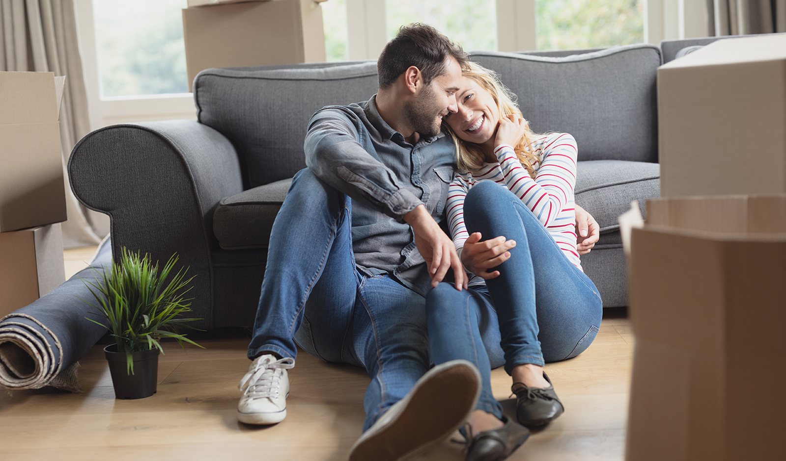 couple-cuddling-on-living-room-floor