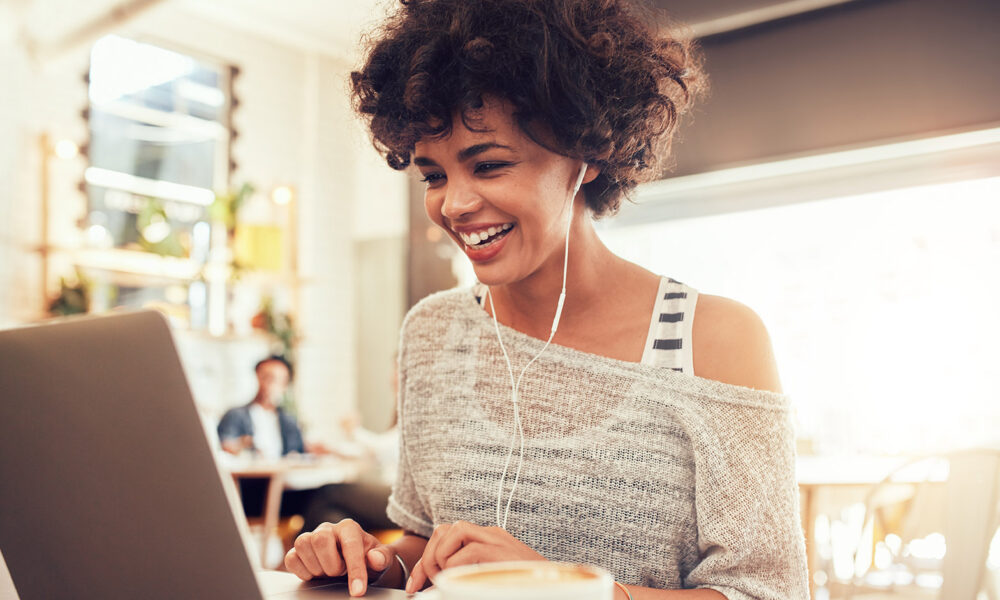 woman-on-computer-smiling-beautiful-natural-hair