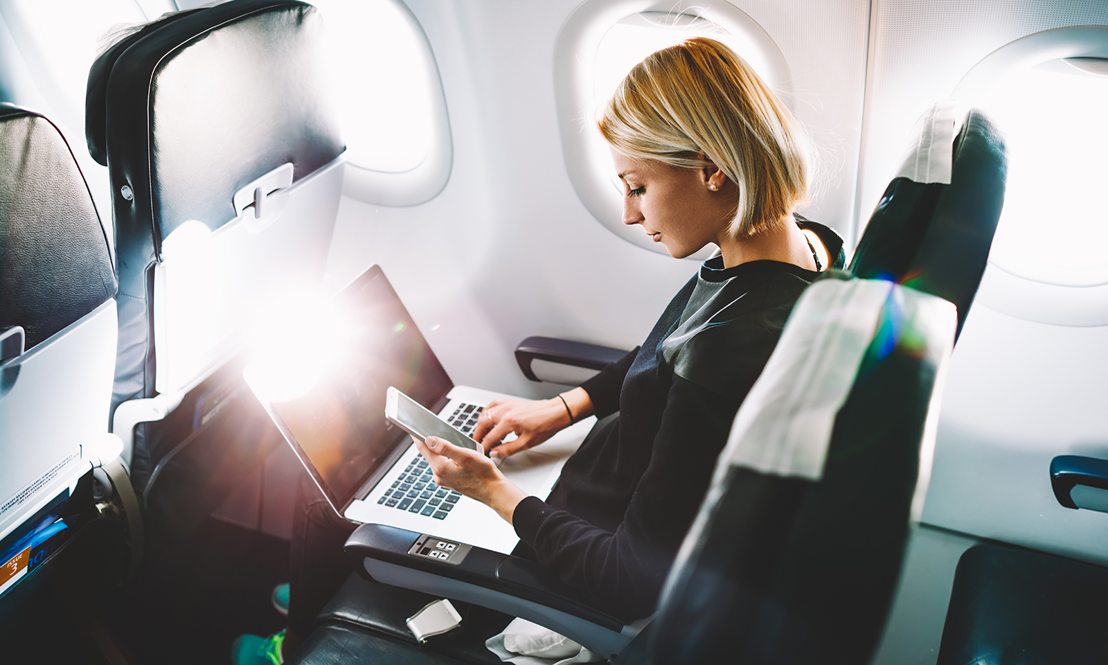 woman-working-while-on-an-airplane