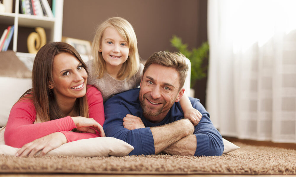 family-laying-on-the-floor-of-their-living-room