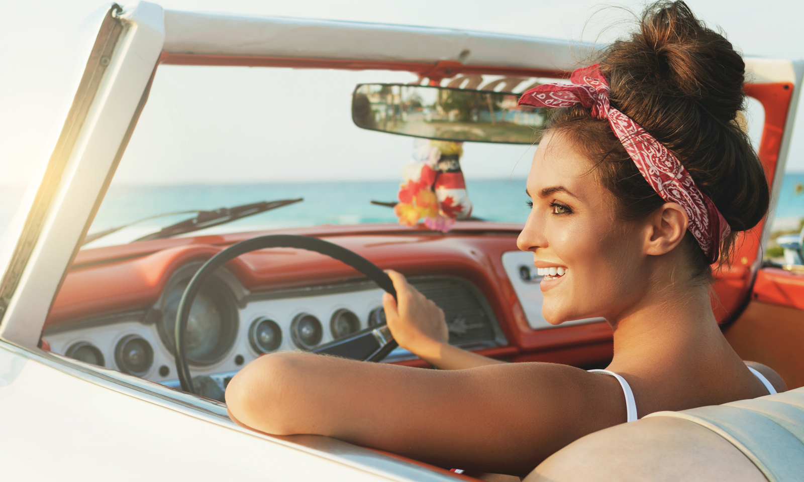 AdobeStock-woman-classic-car-bandana-hair-up, How to Wear a Bandana and Still Look Sexy AF