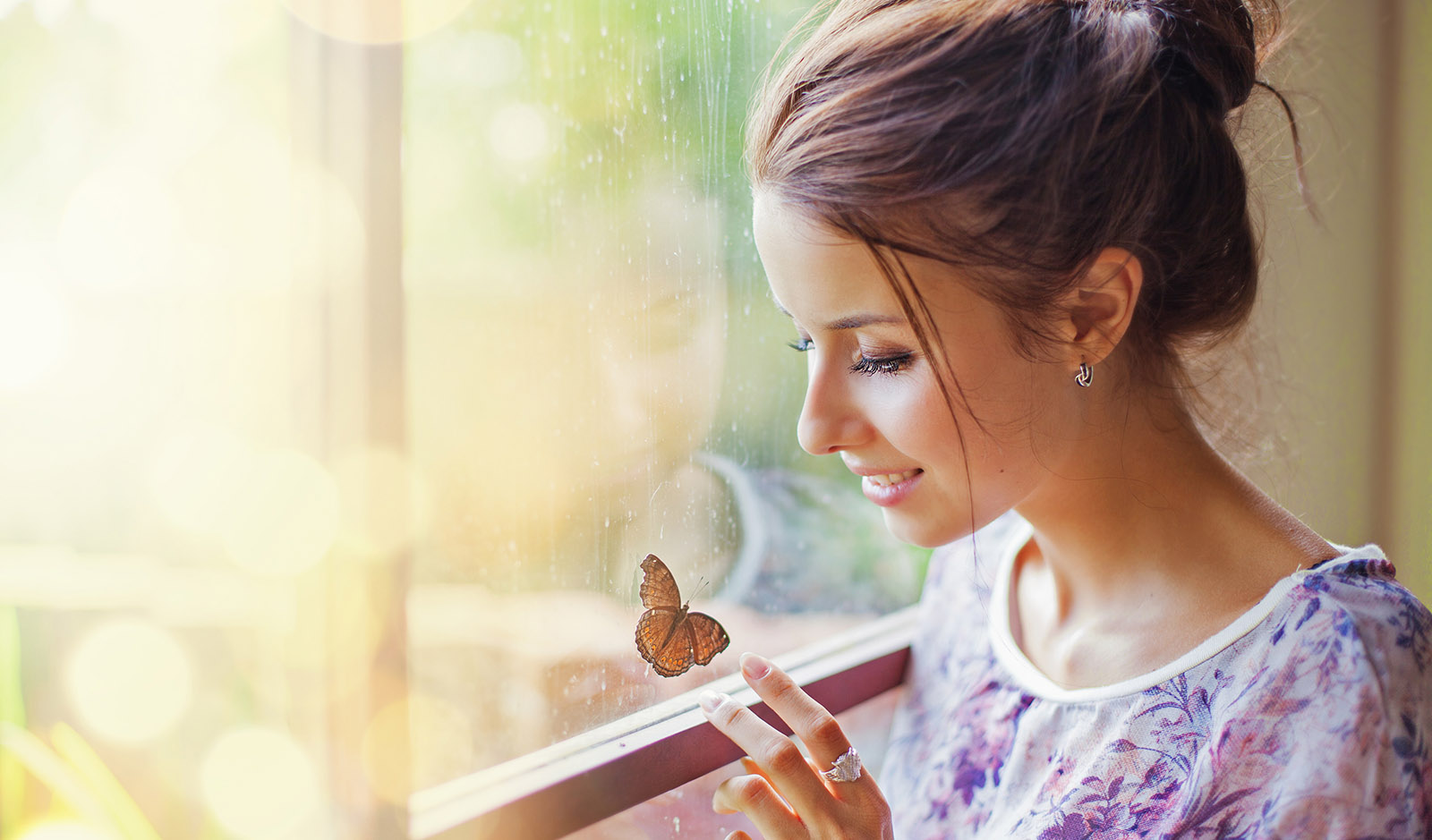 woman-looking-through-a-window-at-a-butterfly