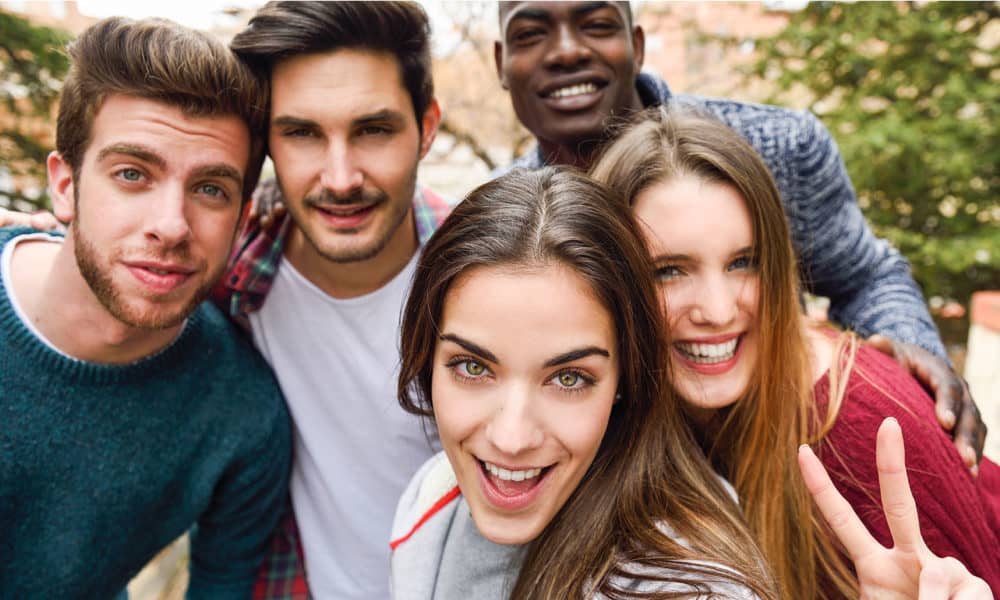 Group of multi-ethnic young people having fun together outdoors